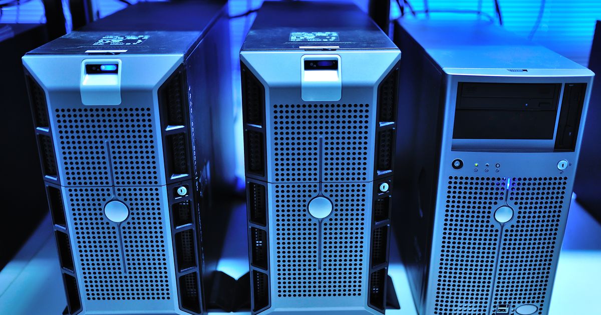 Rack-mounted servers lit in blue inside a data center